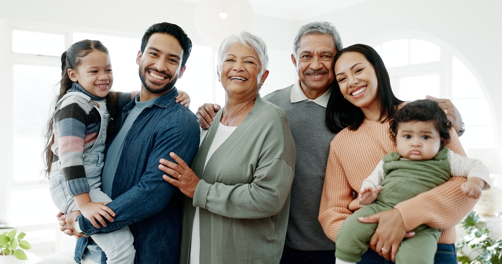 Large multi-generational family smiling in a group photo.