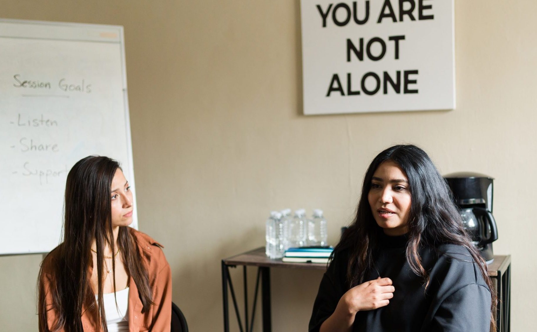 Peer support group with a sign that says "You are not alone"